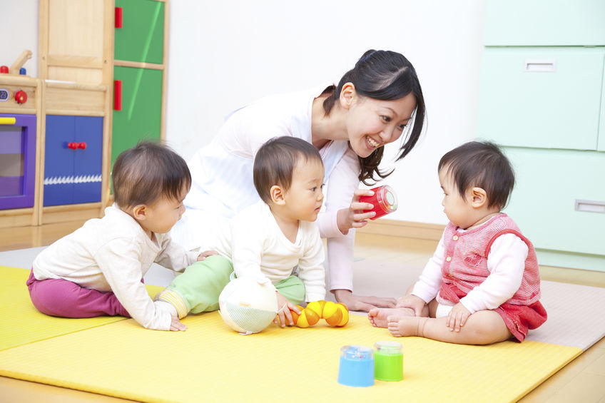femme avec des enfants en train de jouer à la crèche